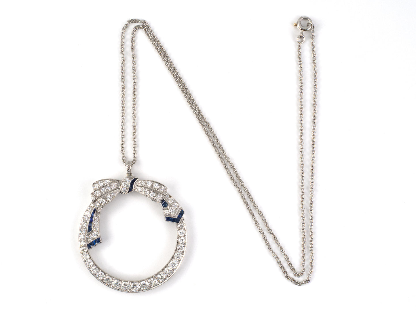45570 - Art Deco Platinum Diamond Sapphire Bow Ribbon Circle Pendant Necklace