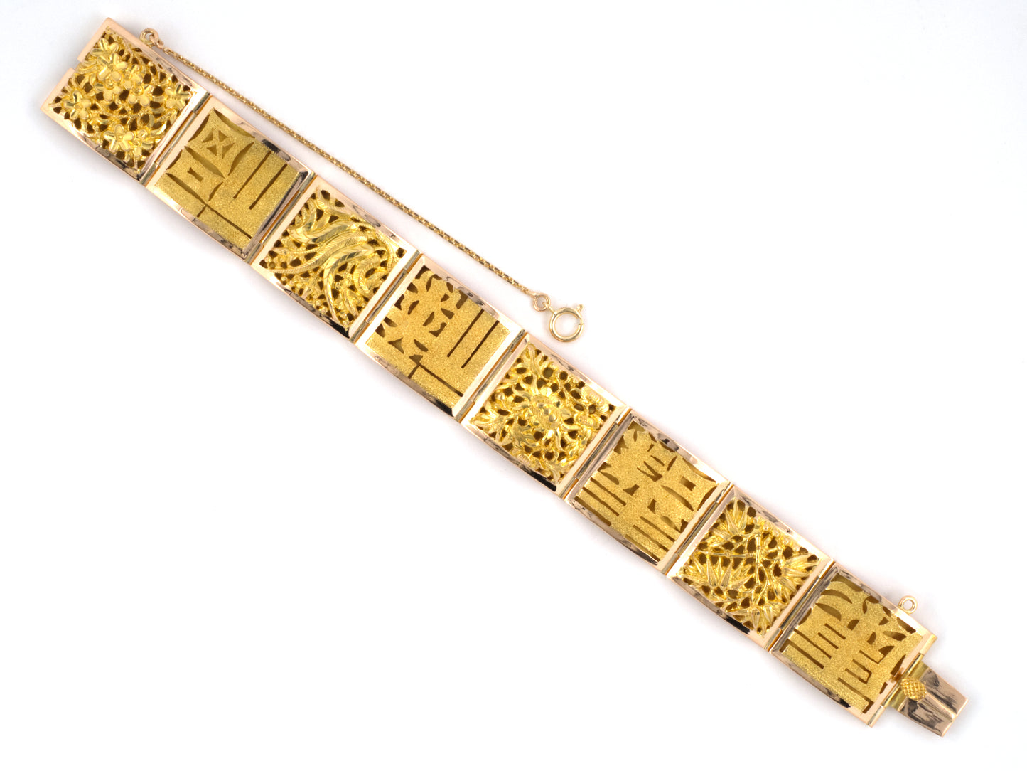 74007 - Circa 1950s Gold Carved Chinese Design Hinged Panel Wisdom/Happiness Wealth Longevity Health Bracelet