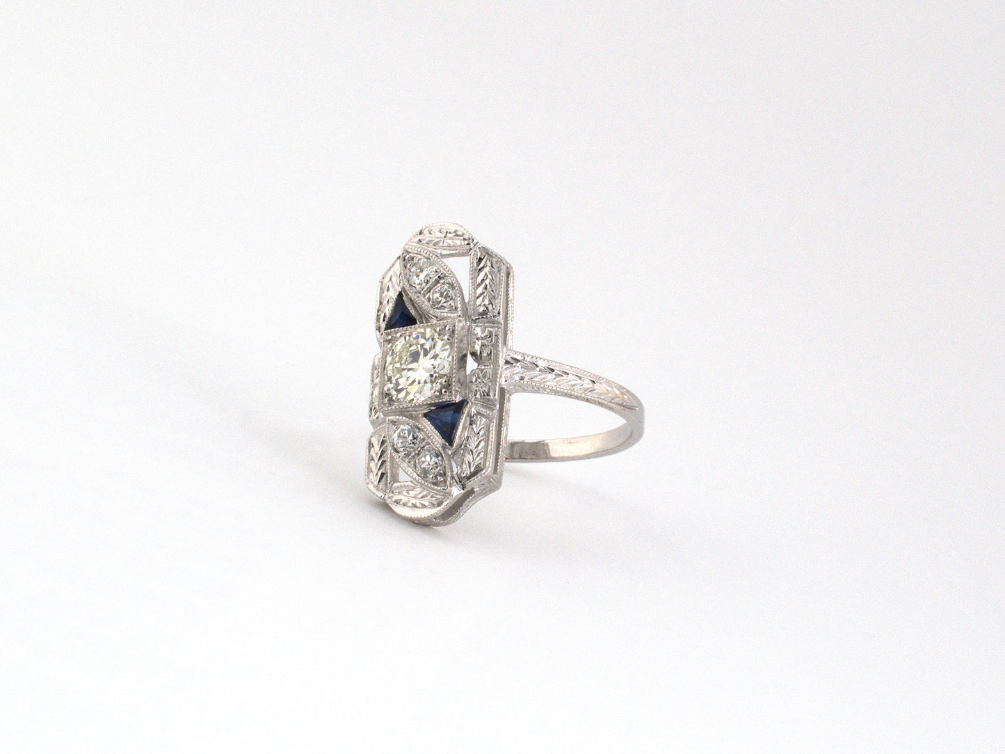 902322 - Art Deco Gold Platinum Diamond Synthetic Sapphire Carved Open Work Dinner Ring