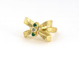 902353 - Circa 1960s Gold Emerald Diamond Carved Bow 3-Stone Ring