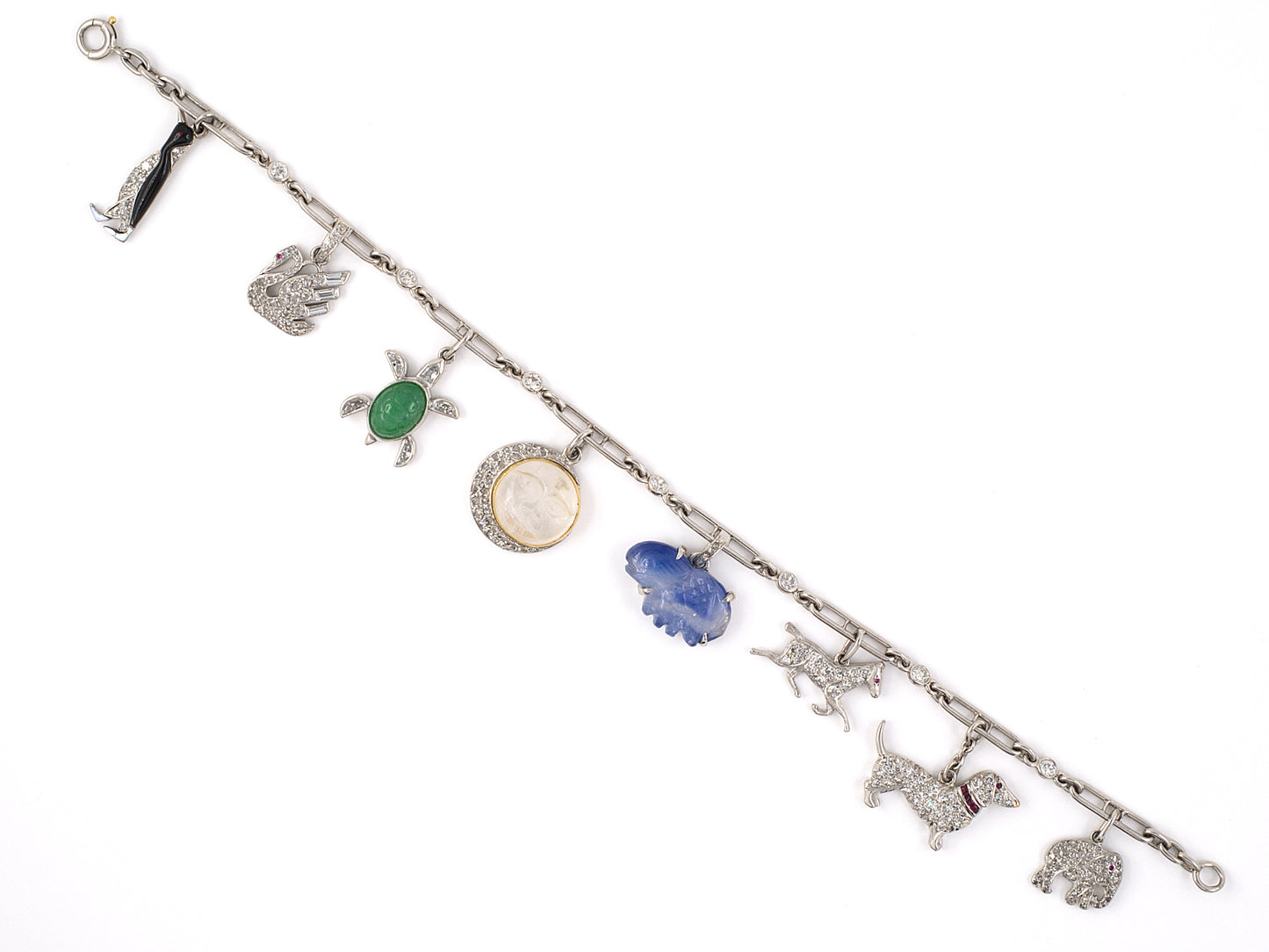73728 - Circa 1920s 1930 Art Deco Cartier Platinum Gold Diamond Kashmir AGL Sapphire Ruby Jadeite Moonstone Enamel Charm Bracelet
