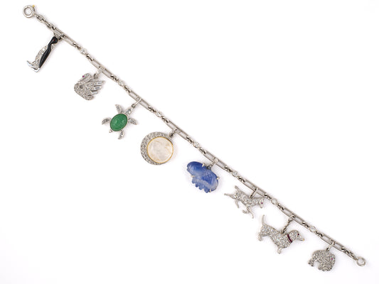 73728 - Circa 1920s 1930 Art Deco Cartier Platinum Gold Diamond Kashmir AGL Sapphire Ruby Jadeite Moonstone Enamel Charm Bracelet