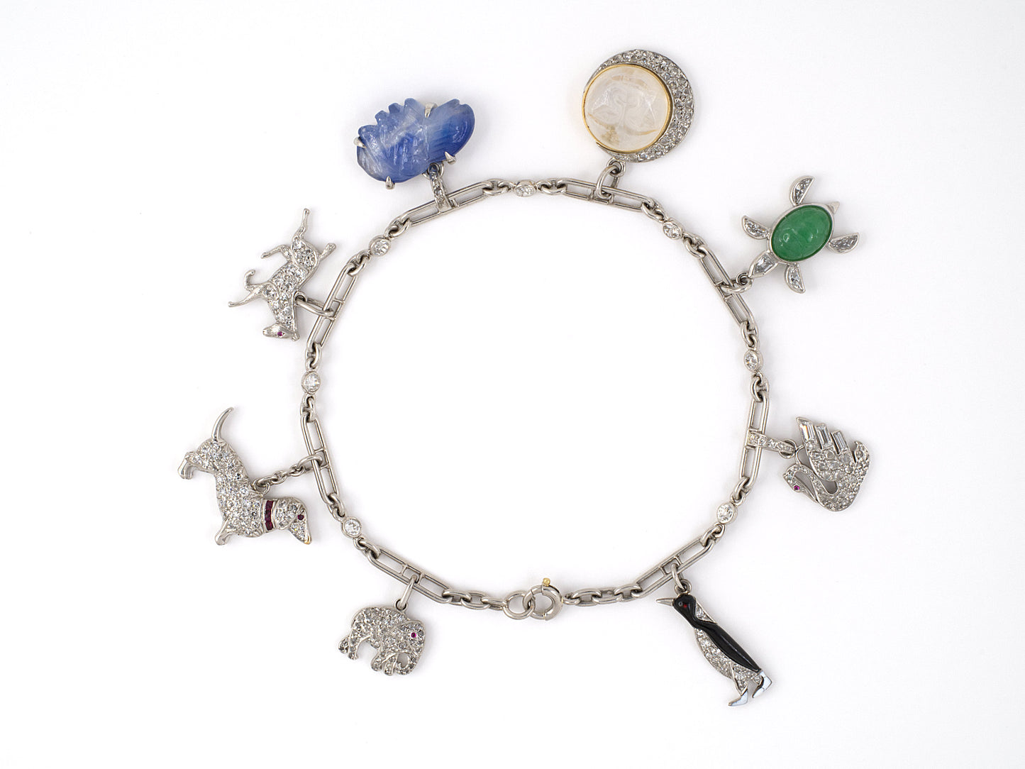 73728 - Circa 1920s 1930 Art Deco Cartier Platinum Gold Diamond Kashmir AGL Sapphire Ruby Jadeite Moonstone Enamel Charm Bracelet